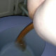 One of our users records his large wife taking a sloppy, wet shit into a plastic bucket while sitting on a porta-potty type chair. She spreads her ass cheeks to show us her dirty butt-hole. Finished product shown in bucket.
